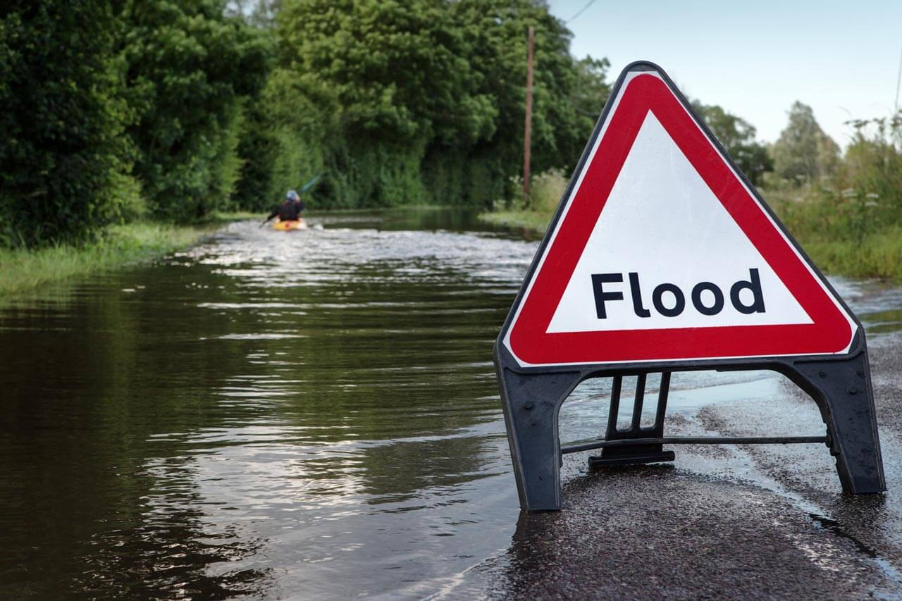 flood warning sign near water