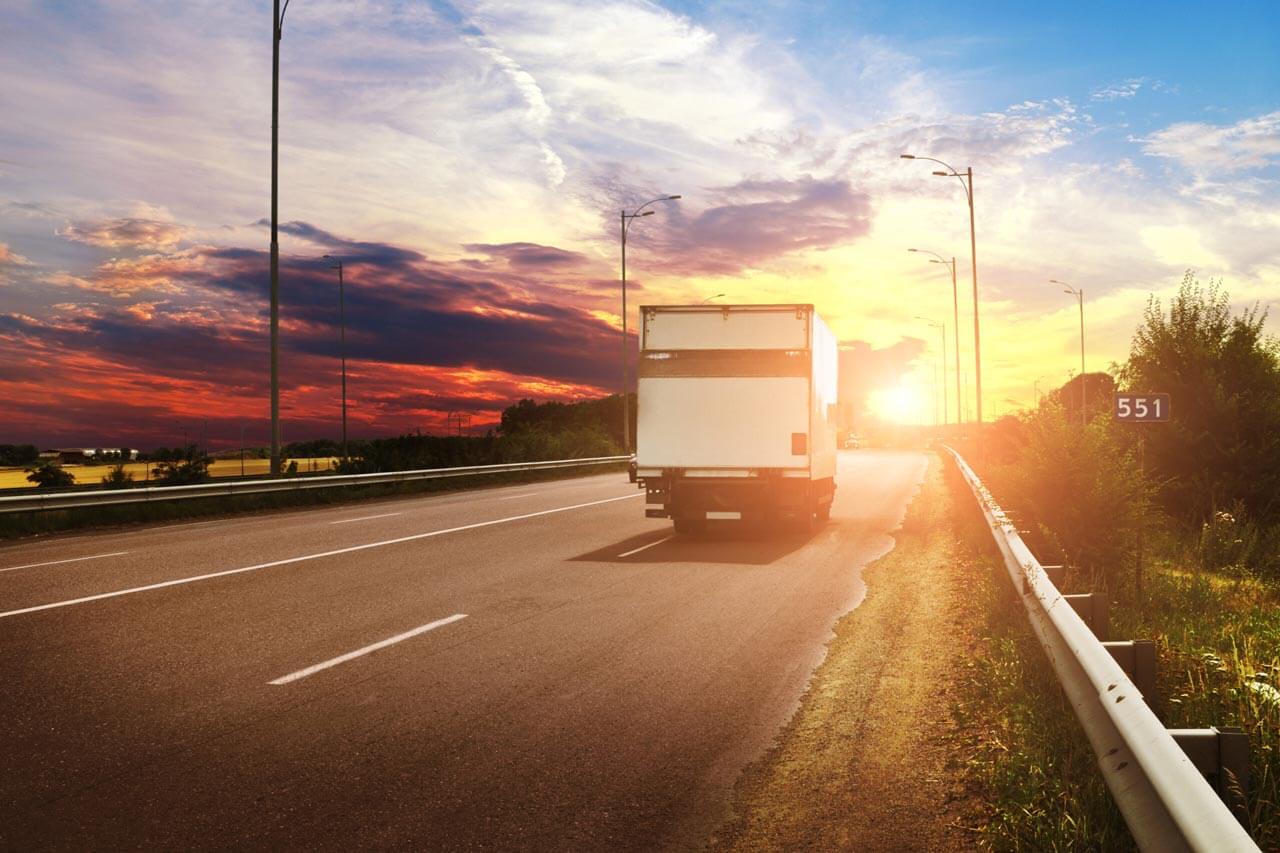 box truck driving off into the sunset
