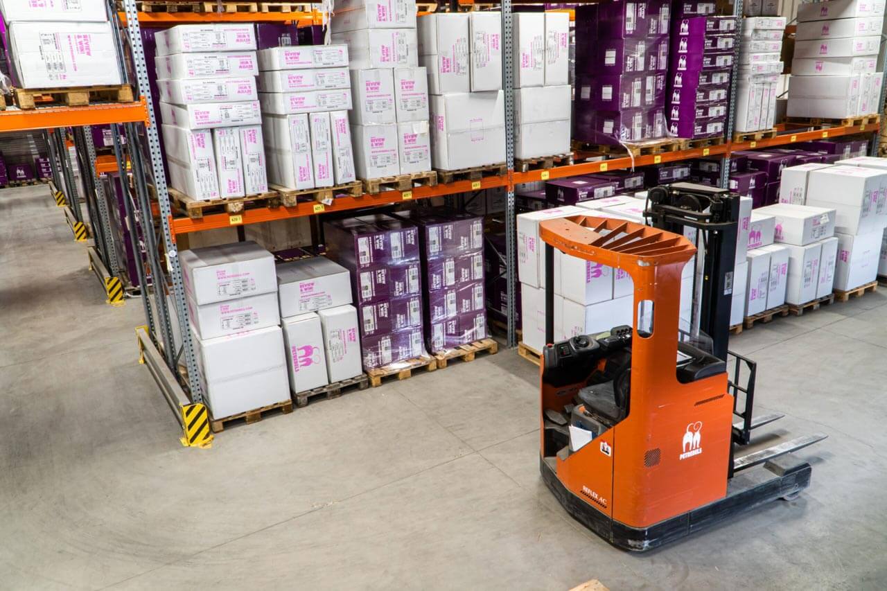 warehouse with orange forklift to the right